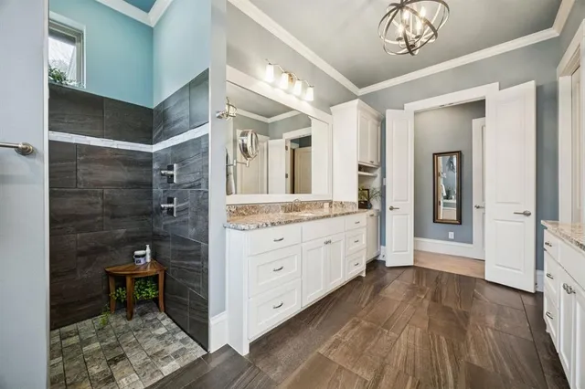 a bathroom with a sink a mirror and a shower