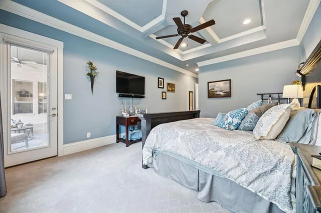 a bedroom with a large bed and a flat screen tv