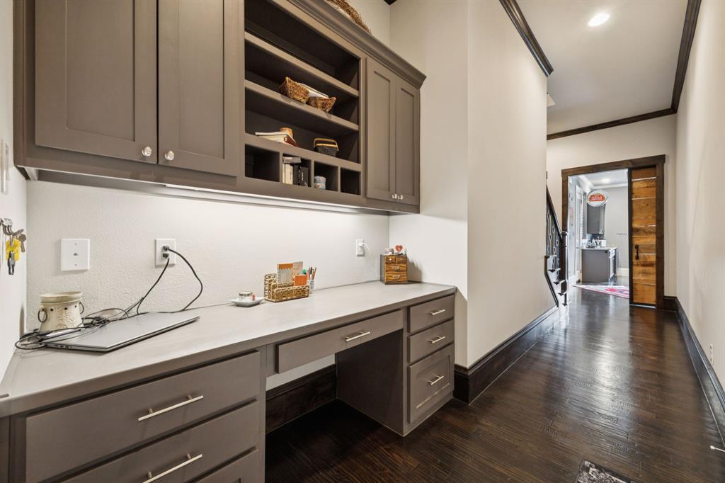 1641 Knox Road Keller, TX 76262 - Photo 24 of 40 a hallway with a sink cabinets and wooden floor