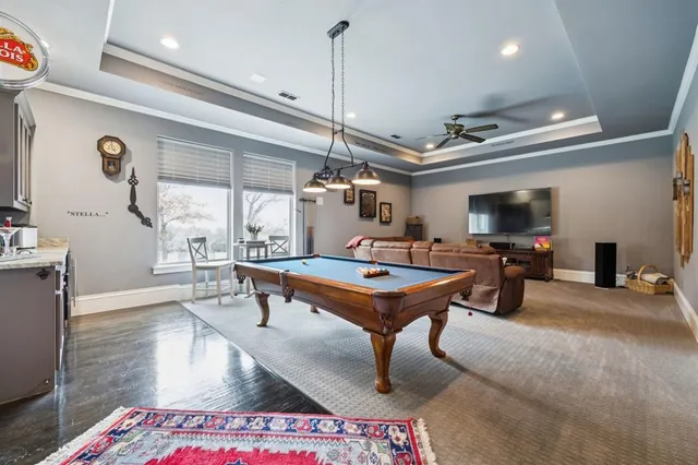 a living room with furniture a rug and a chandelier