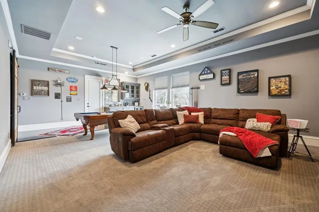 a living room with furniture and a chandelier