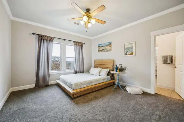 a spacious bedroom with a bed and a chandelier