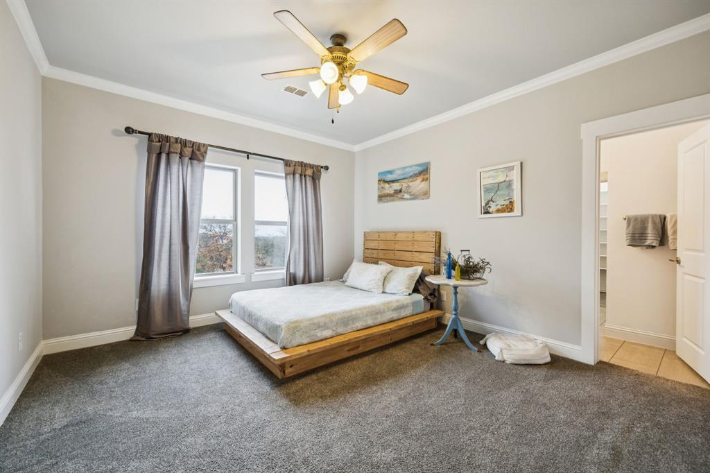 1641 Knox Road Keller, TX 76262 - Photo 27 of 40 a spacious bedroom with a bed and a chandelier