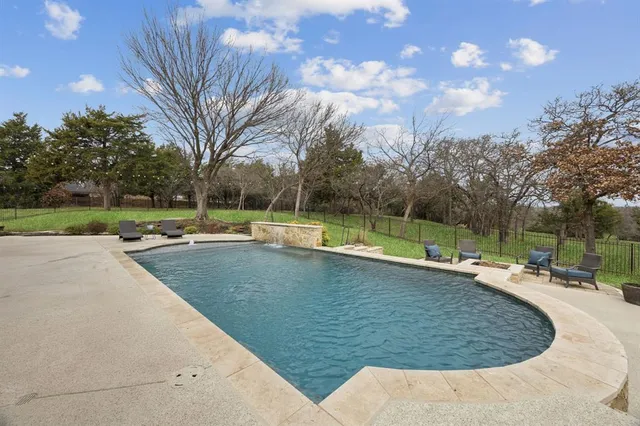 a view of a swimming pool with a sitting area