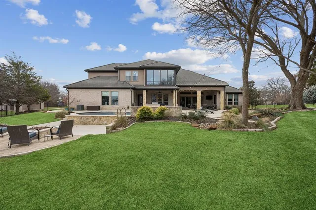 a front view of a house with a yard table and chairs