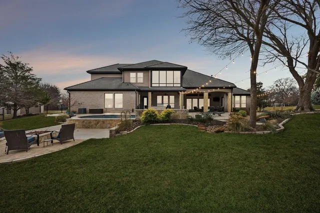 a front view of a house with a yard table and chairs