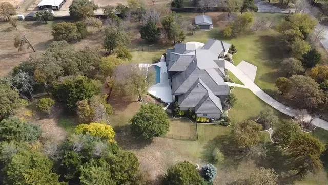 an aerial view of a house with a yard