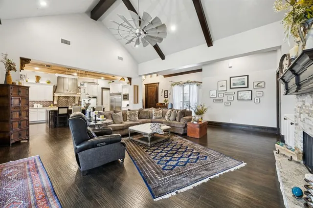 a living room with furniture wooden floor and chandelier