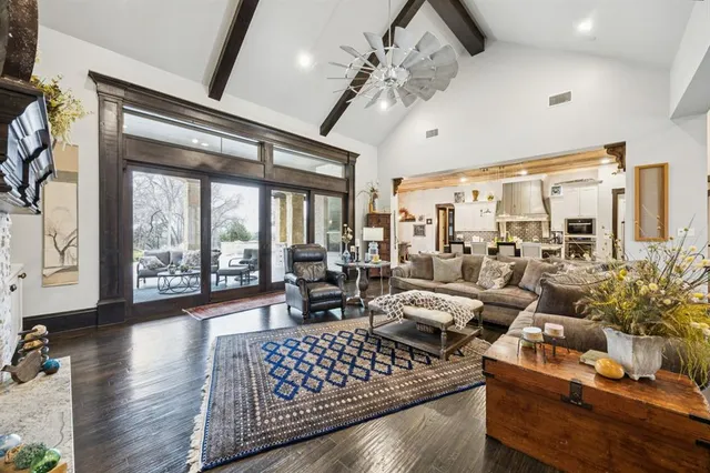 a living room with furniture large window and outdoor view