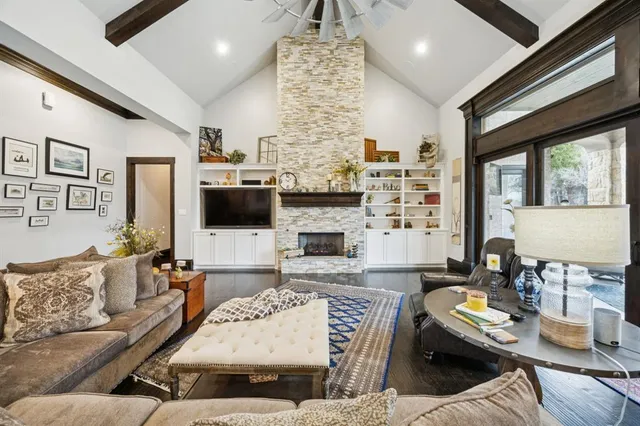a living room with furniture a flat screen tv and a fireplace