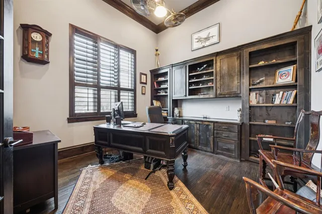 a view of a workspace with furniture and a window