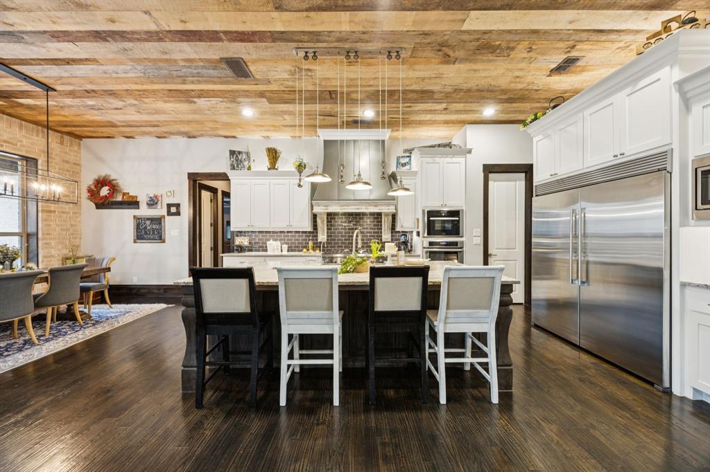 1641 Knox Road Keller, TX 76262 - Photo 10 of 40 a dining room with stainless steel appliances kitchen island granite countertop a dining table chairs and granite counter tops