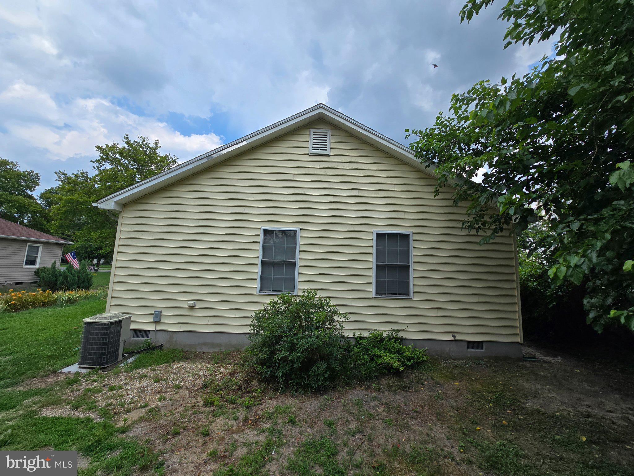 8981 Sharptown Road Laurel, DE 19956 - Photo 4 of 34 Charming yellow home with lush greenery.