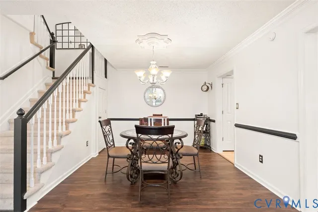 a view of a dining room with furniture a chandelier and wooden floor