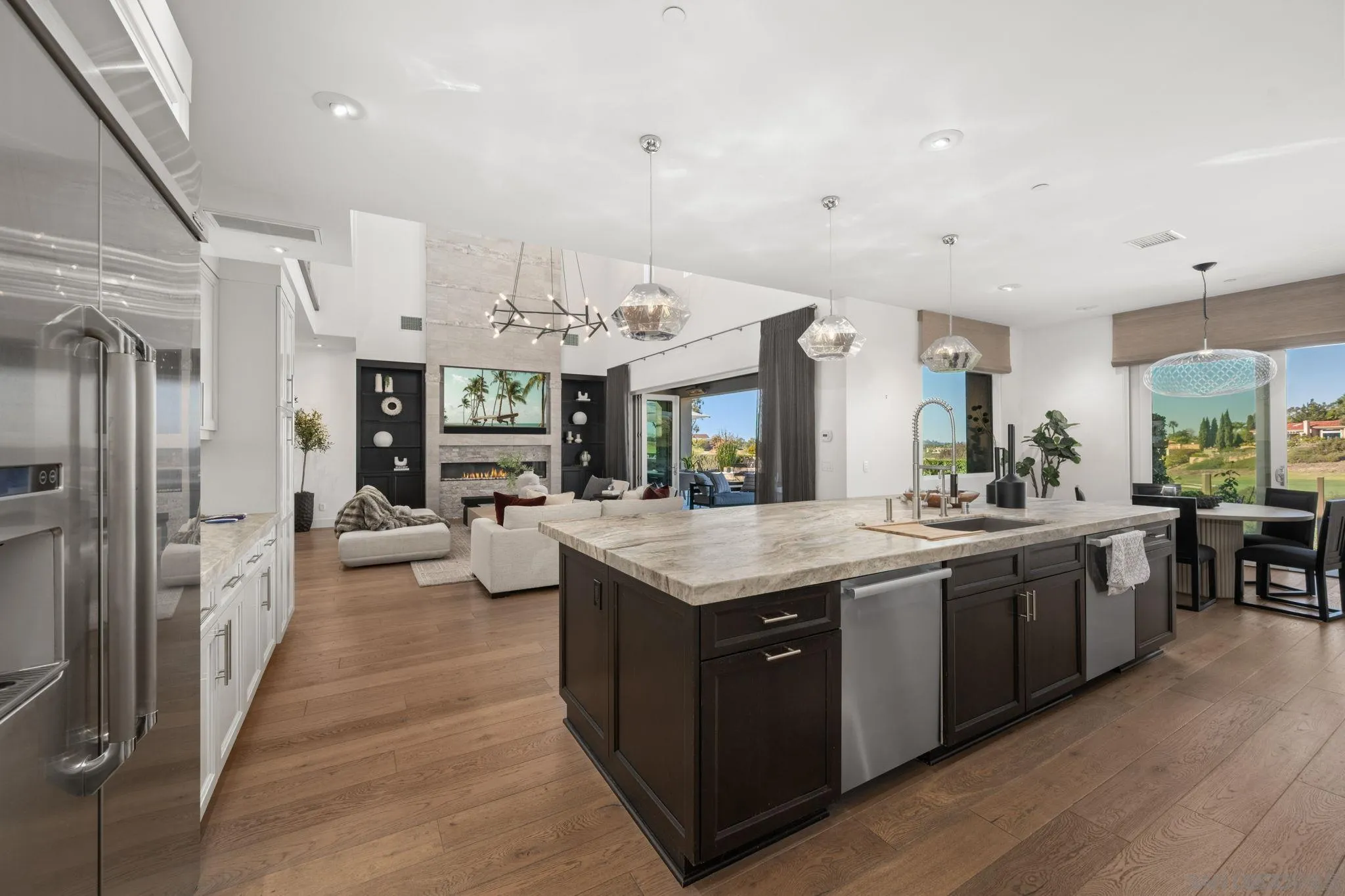6968 St Andrews Road Rancho Santa Fe, CA 92067 - Photo 6 of 23 With every possible amenity: Miele Cappuccino machine, refrigerator drawers, wine refrigerator, Butler's pantry and large walk-ion pantry, 6 burned gas stove with two overs & additional wall over and warming drawer. Stunning, custom slab sone counters...
