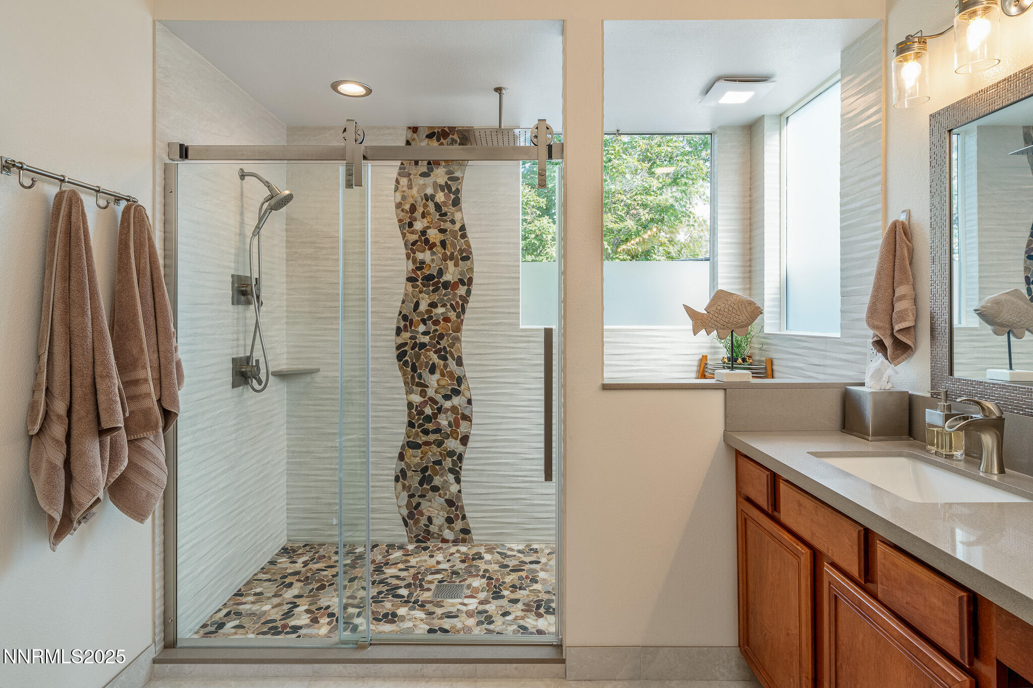 10600 Blue Moon Court Reno, NV 89521 - Photo 17 of 36 a bathroom with a shower sink and a mirror
