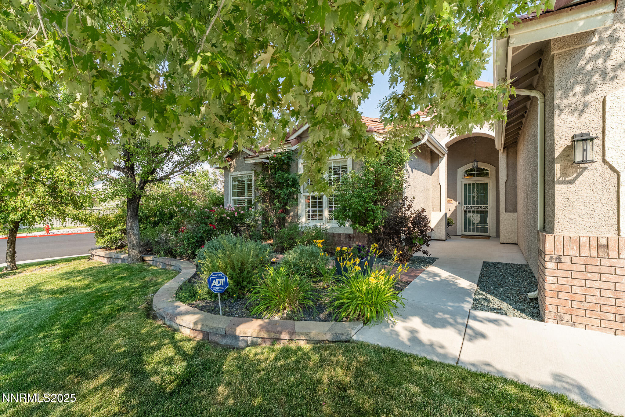 10600 Blue Moon Court Reno, NV 89521 - Photo 3 of 36 a front view of a house with a yard and fountain