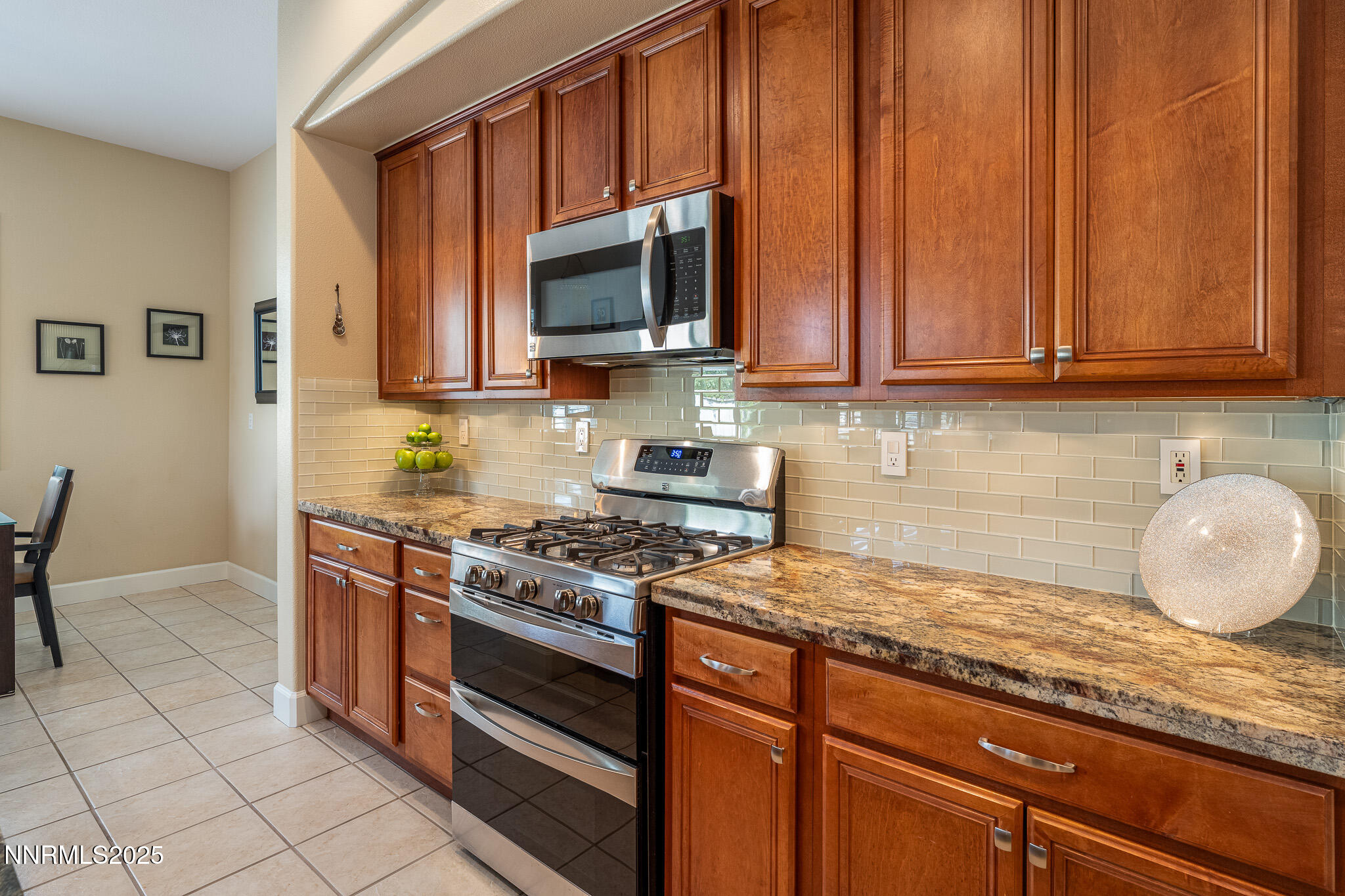 10600 Blue Moon Court Reno, NV 89521 - Photo 8 of 36 a kitchen with granite countertop a stove top oven microwave and cabinets