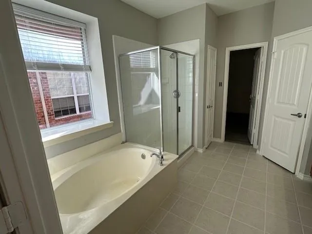 a bathroom with a bathtub and a shower