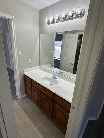 a bathroom with a double vanity sink and a mirror