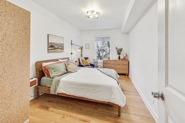 a bed room with a bed and a painting