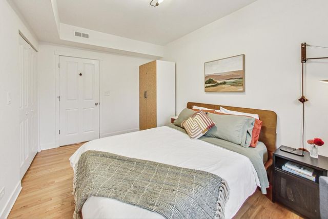 a bedroom with bed and cupboard