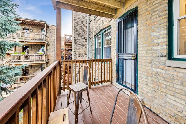 a balcony view with a large window and wooden floor