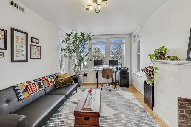 a living room with furniture and a potted plant