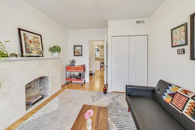 a bedroom with furniture and a fireplace