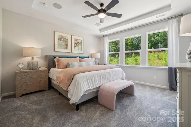 a bed room with a bed and a large window