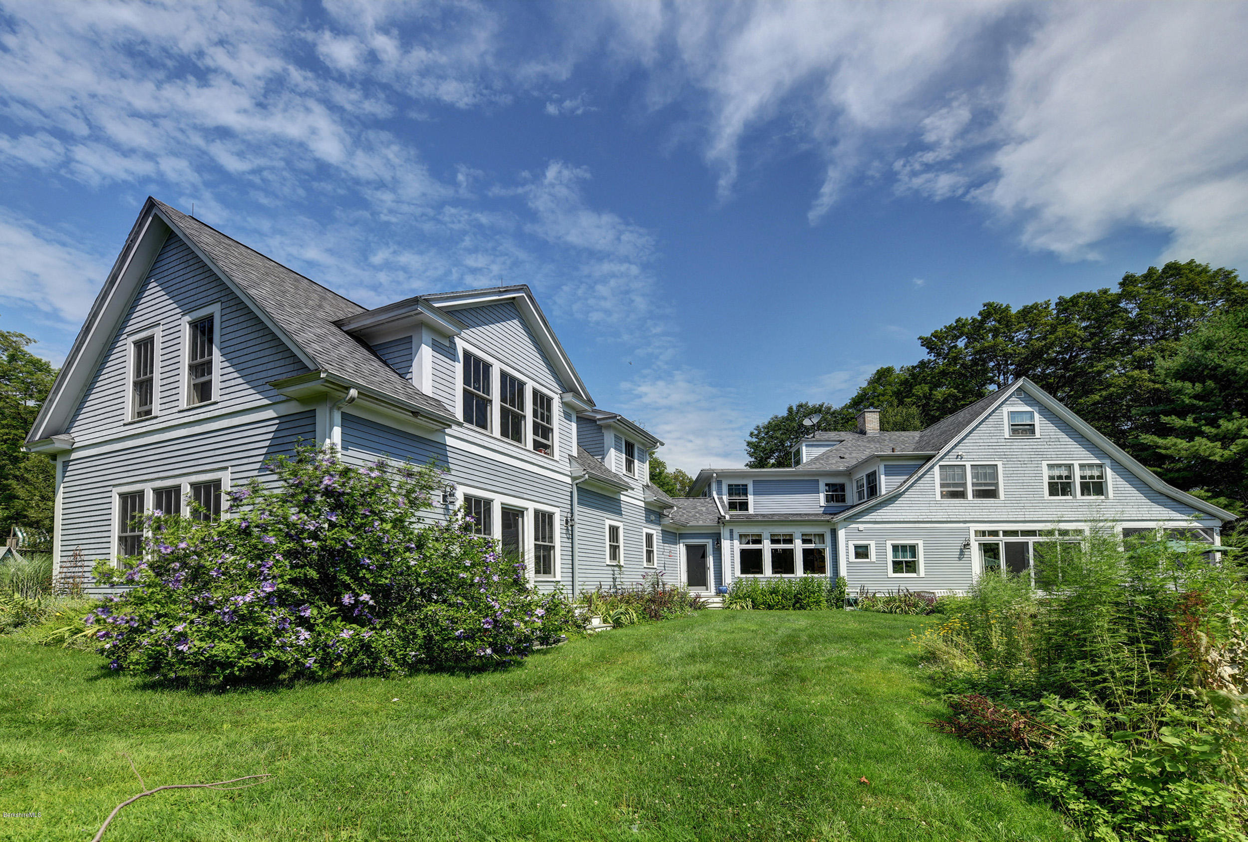 201 Rossiter Road Richmond, MA 01254 - Photo 40 of 52 a view of a white house next to a yard with big trees