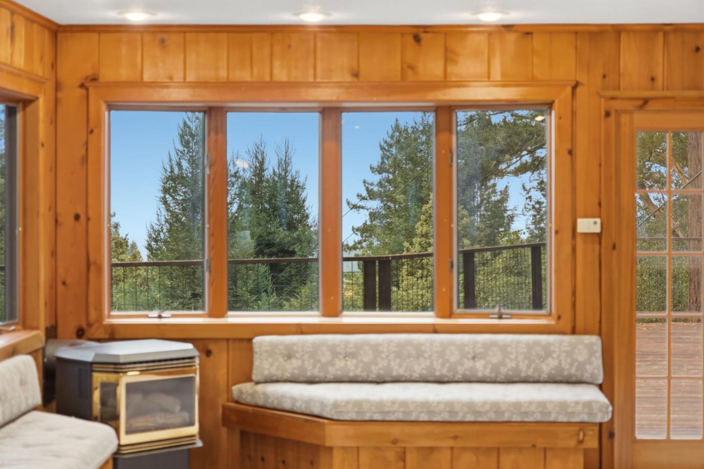 15245 Stetson Road Los Gatos, CA 95033 - Photo 20 of 60 a living room with a large window and floor to ceiling windows