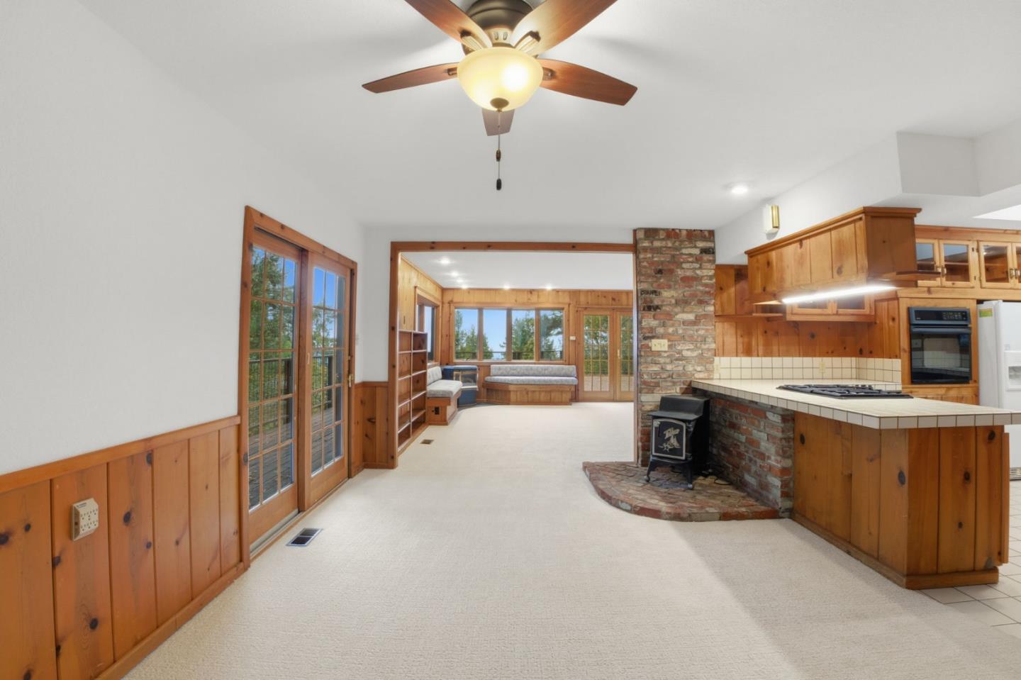 15245 Stetson Road Los Gatos, CA 95033 - Photo 26 of 60 a large kitchen with stainless steel appliances a large counter top a stove and a chandelier