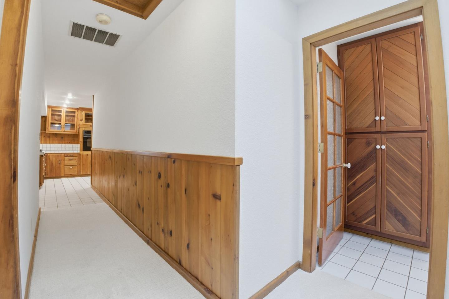 15245 Stetson Road Los Gatos, CA 95033 - Photo 36 of 60 a view of a hallway with wooden cabinet and staircase