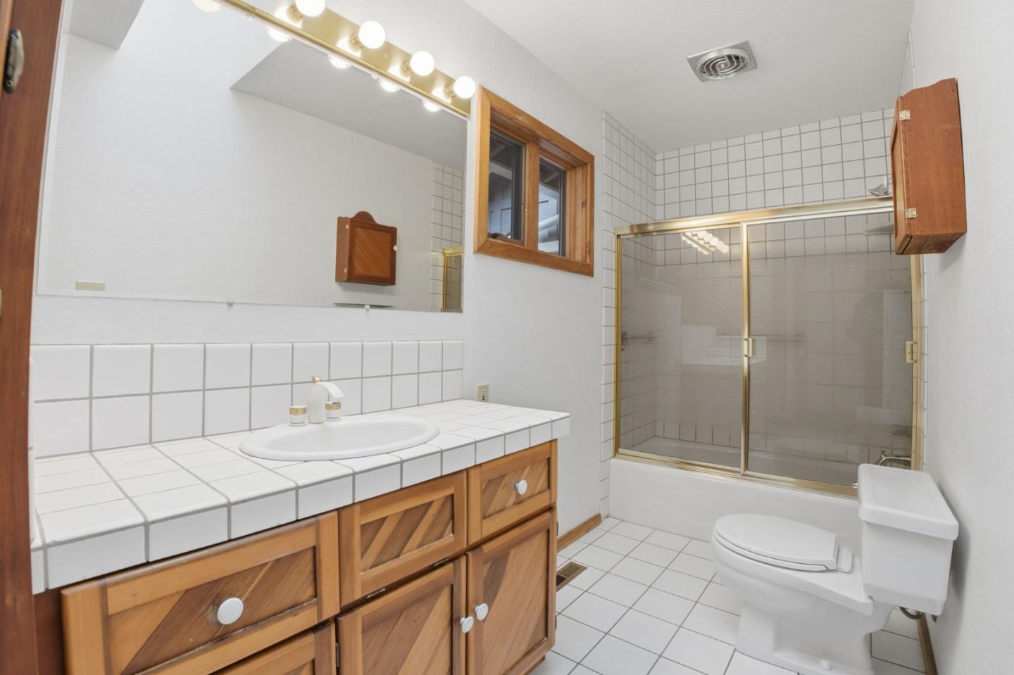 15245 Stetson Road Los Gatos, CA 95033 - Photo 37 of 60 a bathroom with a sink a toilet and shower