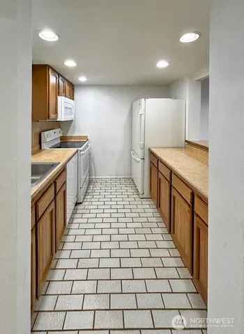 a kitchen with stainless steel appliances a stove a sink and a refrigerator