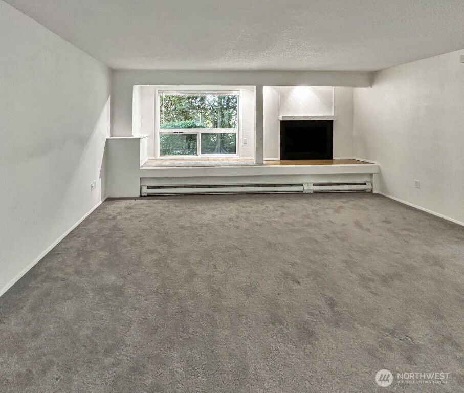 7571 Old Redmond Road, Unit 7 Redmond, WA 98052 - Photo 8 of 17 an empty room with windows