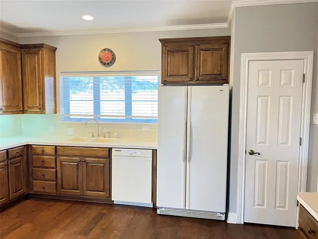a view of a kitchen with a sink and dishwasher next to a window