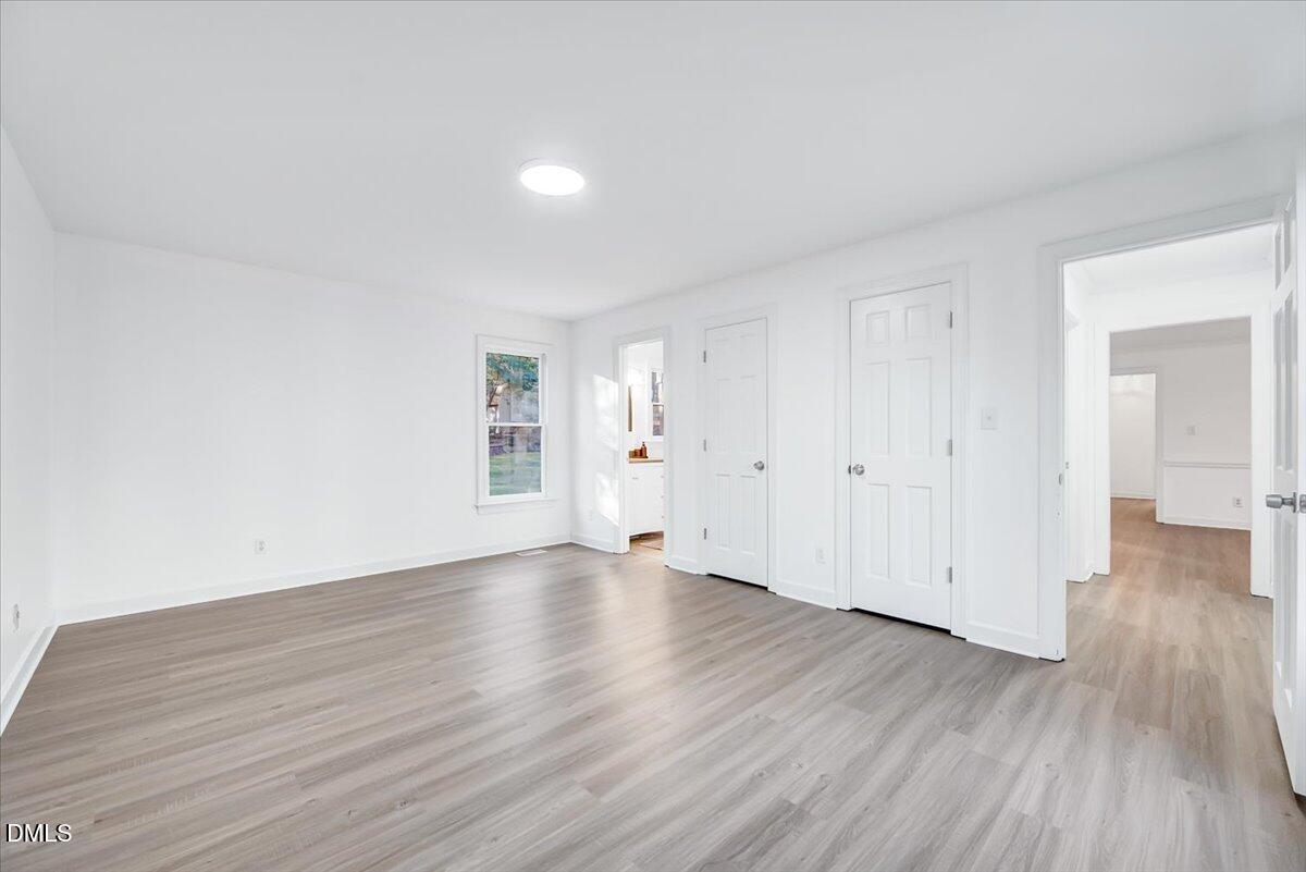 1208 Turner Farms Road Garner, NC 27529 - Photo 12 of 38 a view of an empty room and wooden floor
