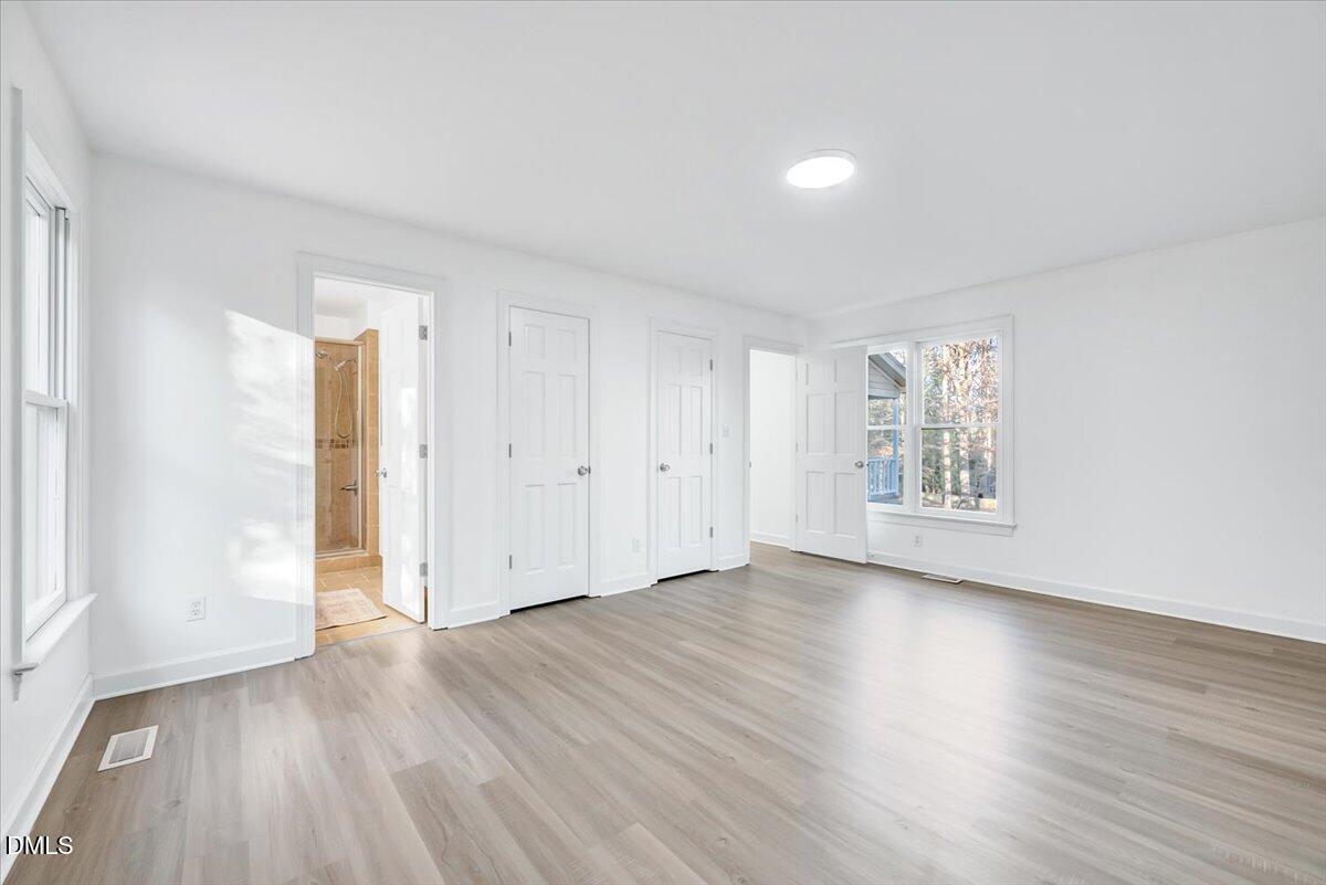 1208 Turner Farms Road Garner, NC 27529 - Photo 13 of 38 an empty room with wooden floor and windows