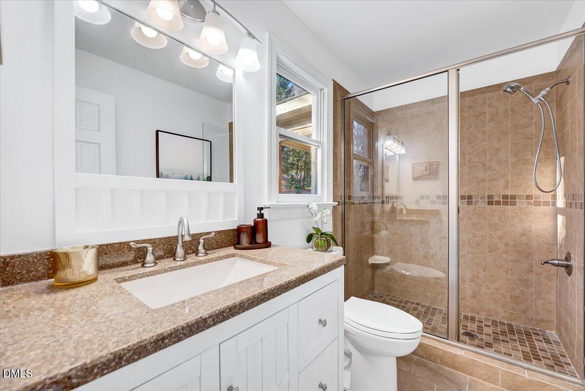 1208 Turner Farms Road Garner, NC 27529 - Photo 14 of 38 a bathroom with a granite countertop sink toilet and shower
