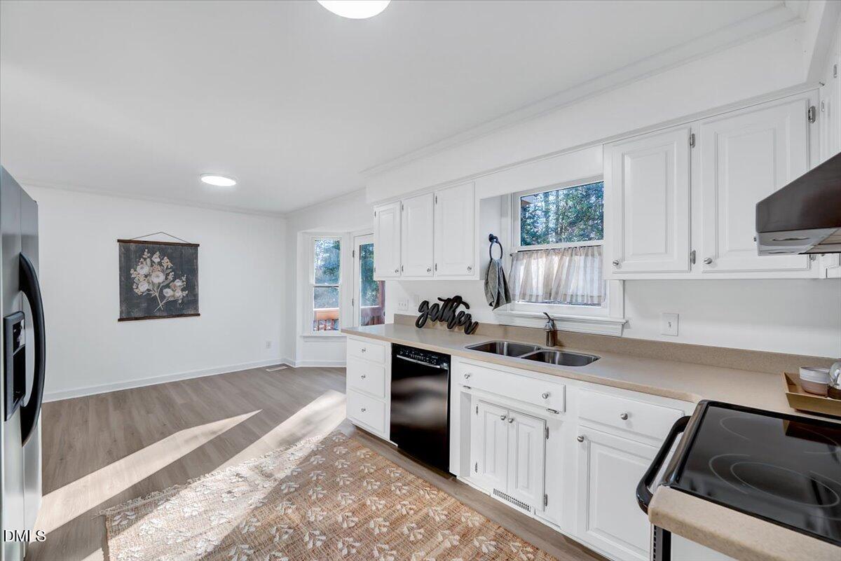 1208 Turner Farms Road Garner, NC 27529 - Photo 17 of 38 a kitchen with granite countertop a sink cabinets stainless steel appliances and a window