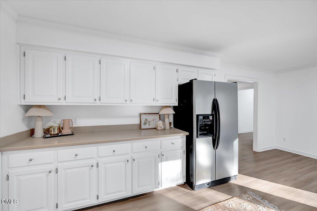 1208 Turner Farms Road Garner, NC 27529 - Photo 18 of 38 a kitchen with stainless steel appliances granite countertop a refrigerator a sink and white cabinets