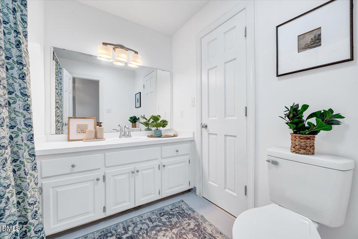 1208 Turner Farms Road Garner, NC 27529 - Photo 20 of 38 a bathroom with a toilet sink and mirror