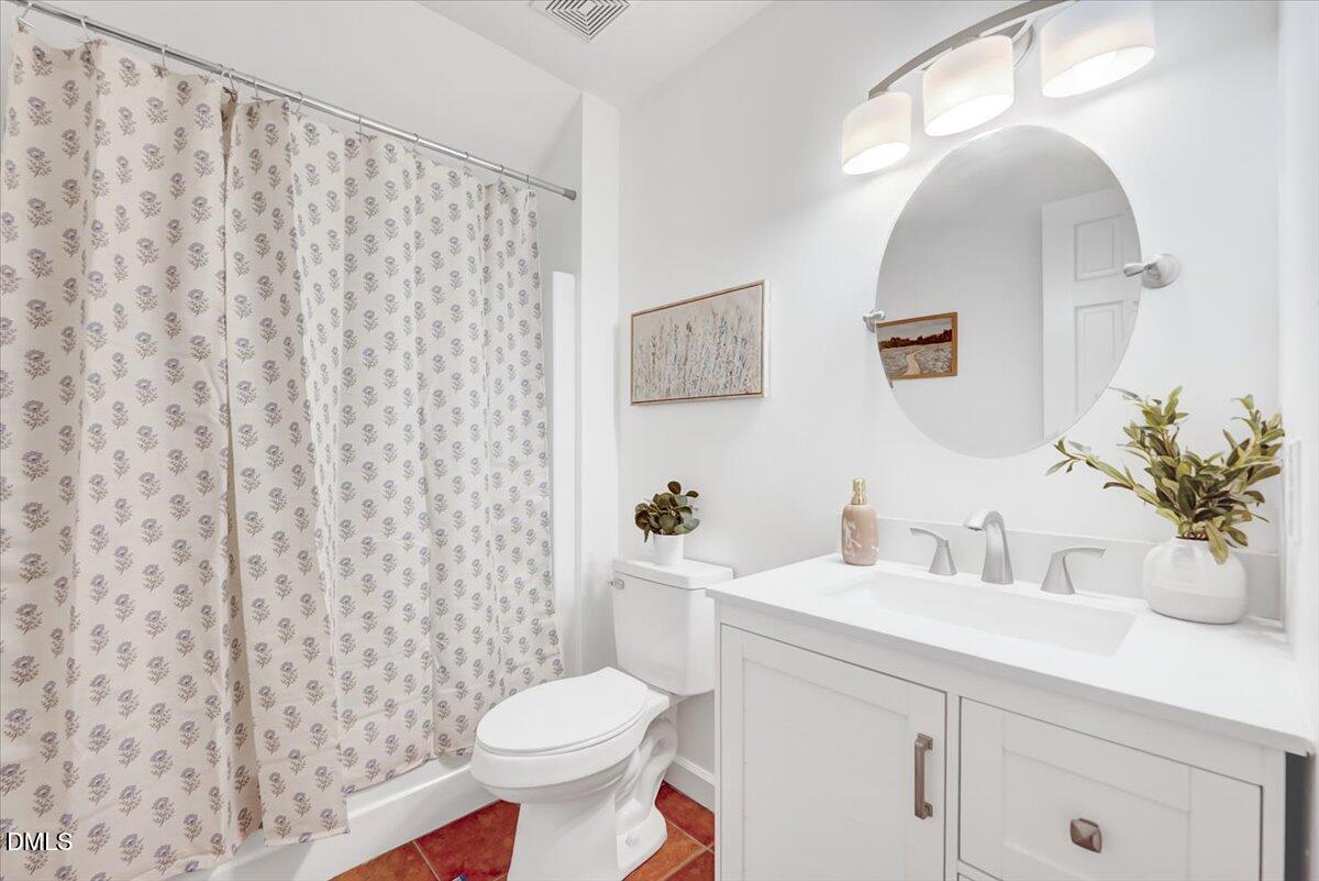 1208 Turner Farms Road Garner, NC 27529 - Photo 25 of 38 a bathroom with a sink a toilet and a mirror