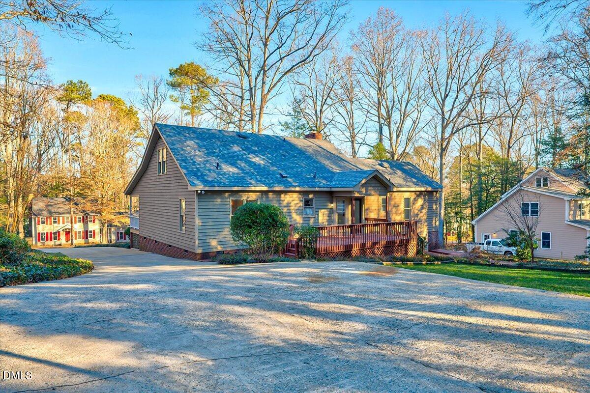 1208 Turner Farms Road Garner, NC 27529 - Photo 31 of 38 a view of a white house with a table and chairs under a large tree