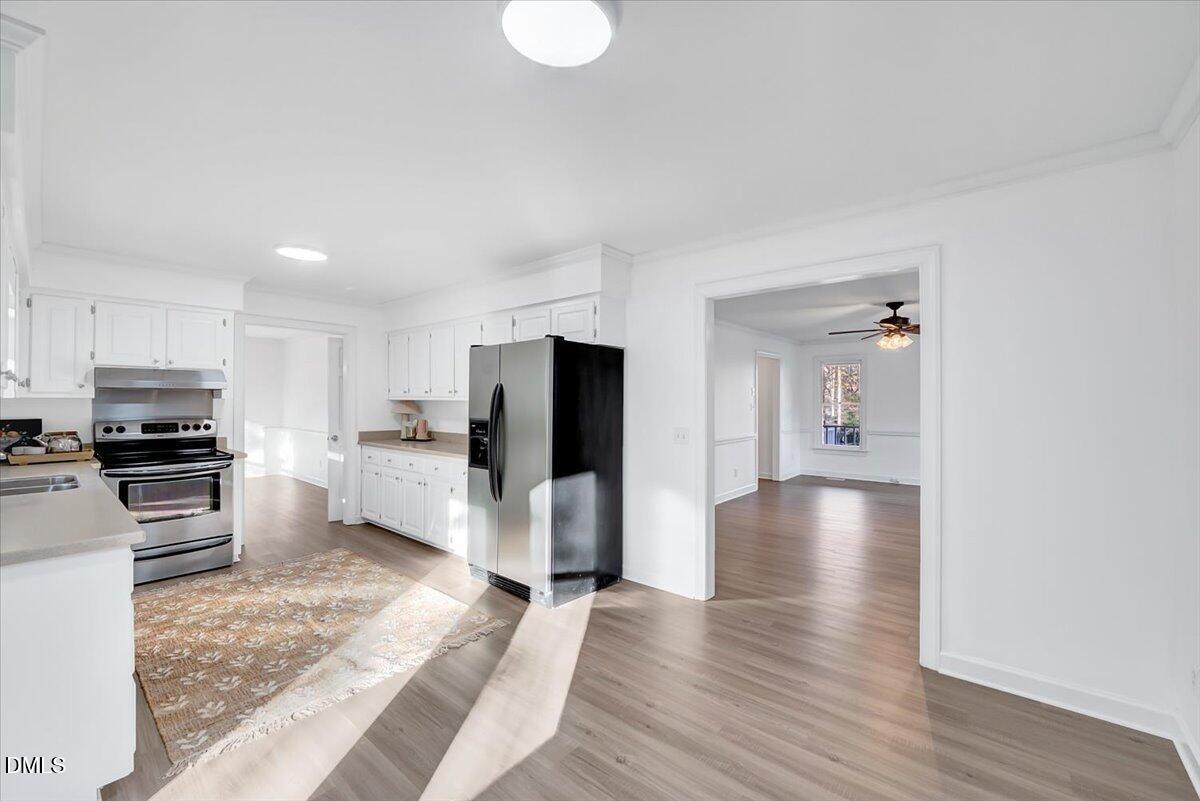 1208 Turner Farms Road Garner, NC 27529 - Photo 5 of 38 a kitchen with a refrigerator and a stove top oven