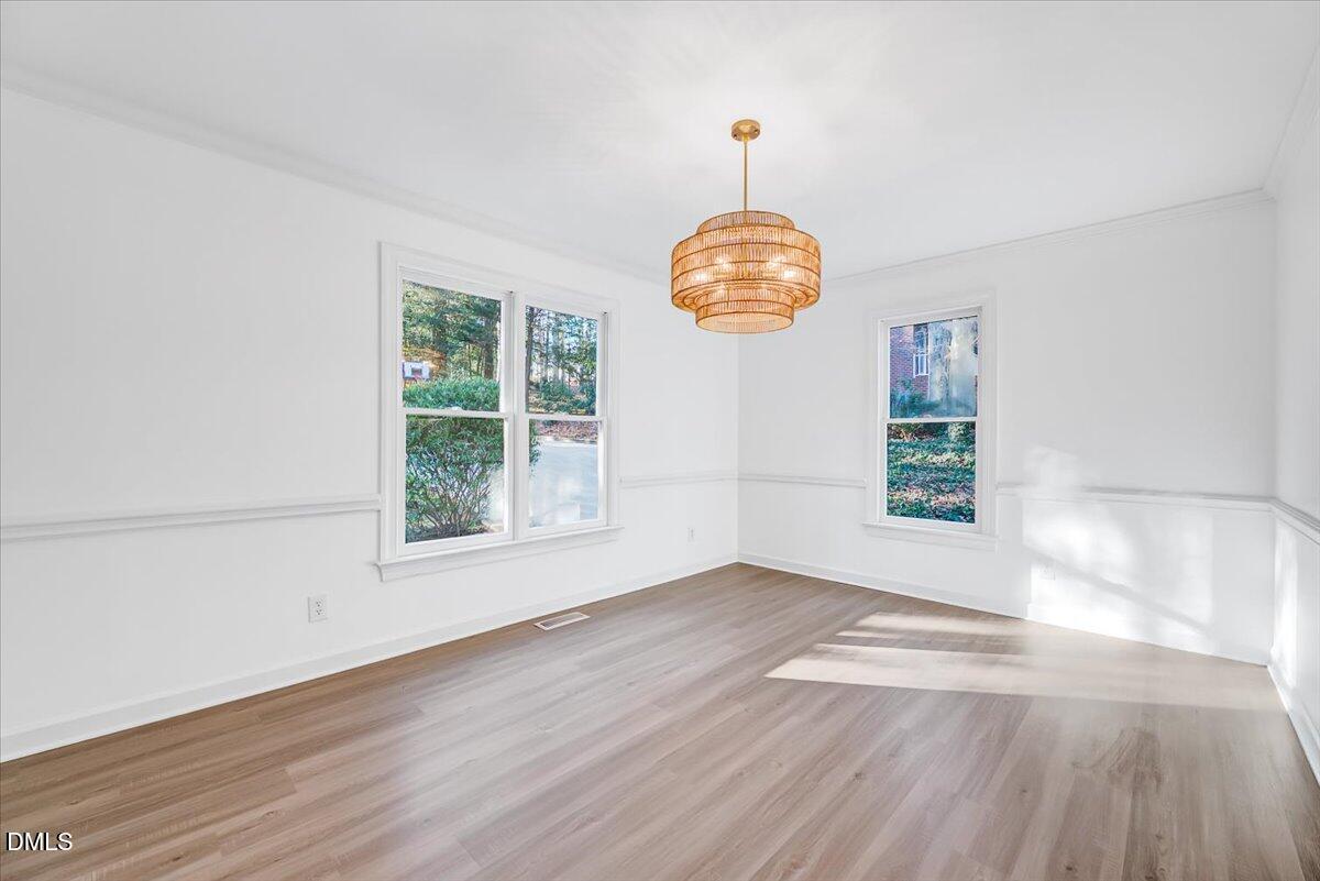 1208 Turner Farms Road Garner, NC 27529 - Photo 6 of 38 an empty room with wooden floor and windows