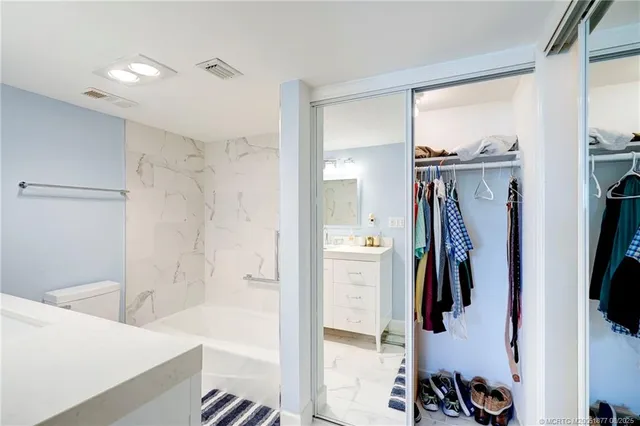 a en suite bathroom with a sink mirror and shower