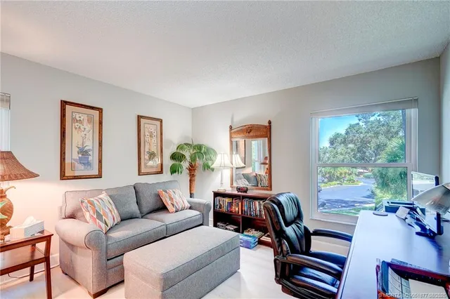 a bedroom with bed and a large window